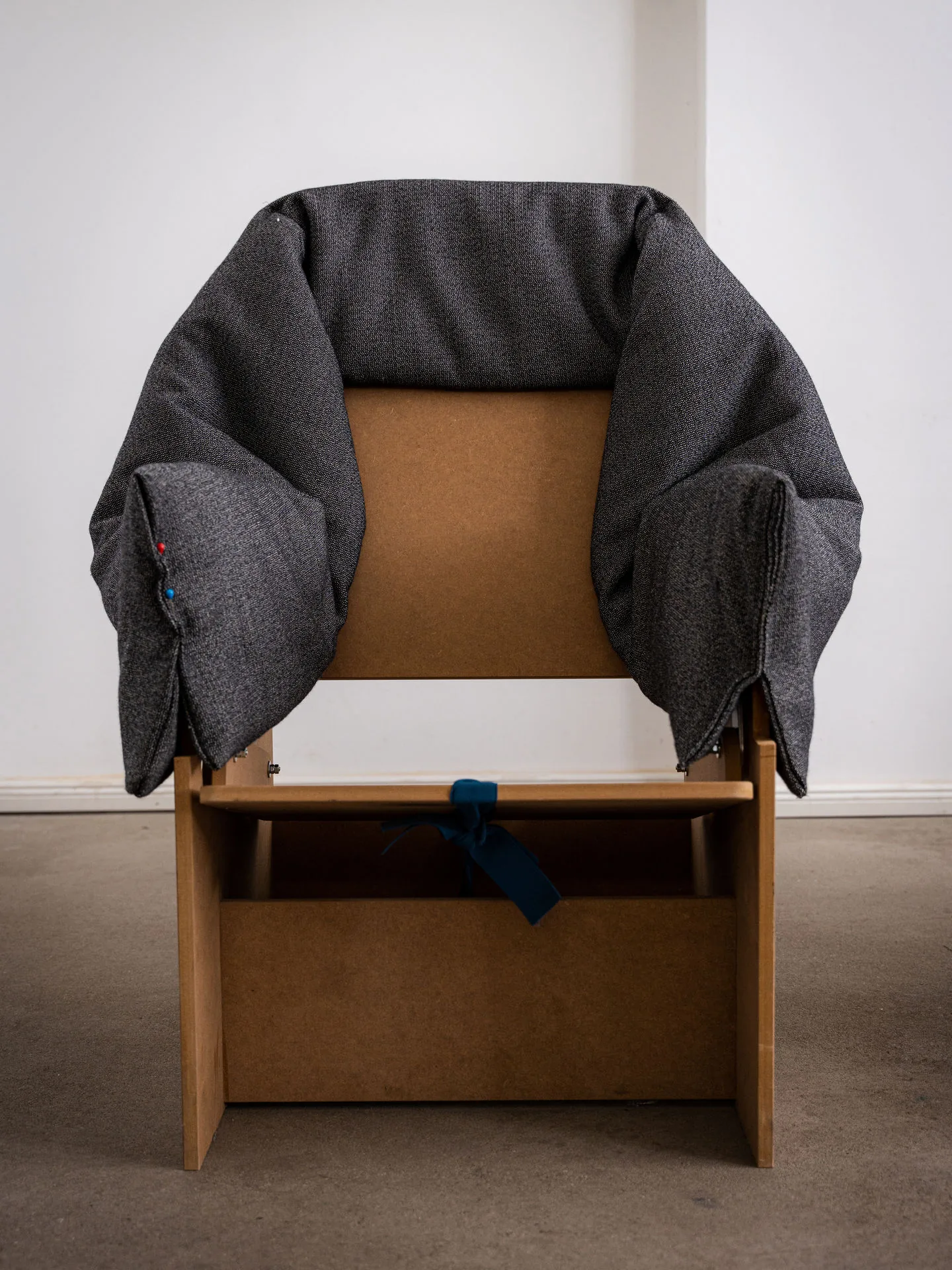 Vitra Bascule: grey fabric cover draped over a wooden model of the lounge chair