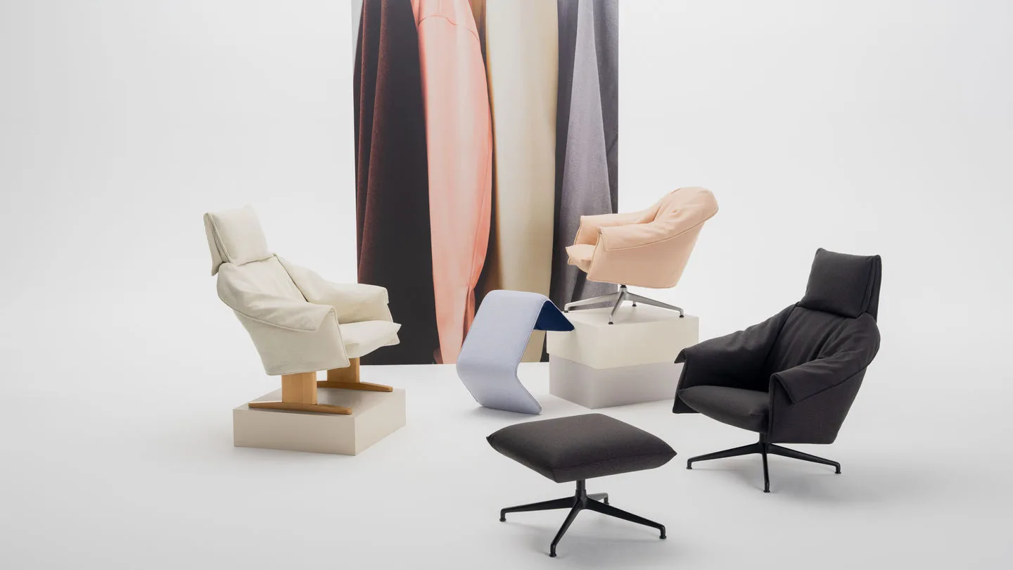 Vitra Bascule: lounge chairs and ottoman in cream, peach and black with fabric samples behind